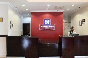 Hampshire hotel front desk with receptionist assisting clients on the telephone